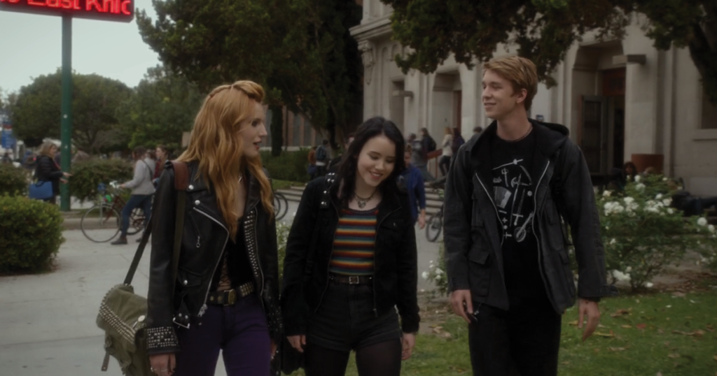 A screenshot from Amityville: The Awakening showing the group of teens. led by Bella Thorne, walking outside their school